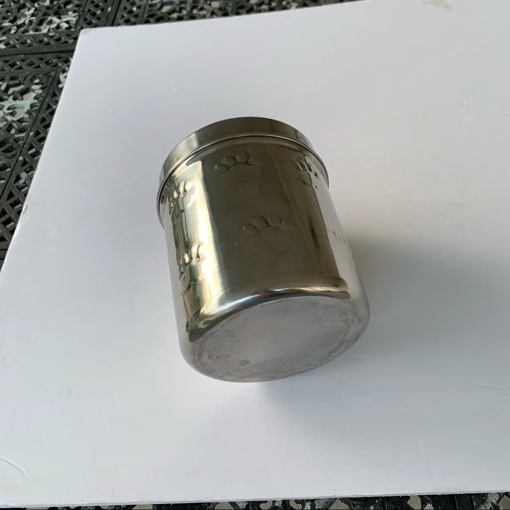 Dog treat canister with paw prints to keep small dog treats